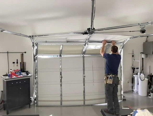 Berlin Garage Door Repair specialist performing precise section replacement on Berlin garage door